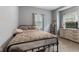Comfortable bedroom features neutral colors, two windows, and carpeted floors at 441 N Temple Ave, Indianapolis, IN 46201
