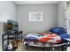 Cozy bedroom featuring hardwood floors, neutral walls, and a comfortable bed, complete with TV at 441 N Temple Ave, Indianapolis, IN 46201