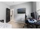 This bedroom features a door to an adjacent room and a wall-mounted television at 441 N Temple Ave, Indianapolis, IN 46201