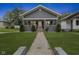 Charming single-story home featuring a manicured front yard with an inviting walkway and covered porch at 441 N Temple Ave, Indianapolis, IN 46201