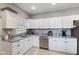 Bright kitchen boasts white cabinets, stainless steel appliances, and granite countertops at 441 N Temple Ave, Indianapolis, IN 46201