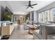 Open-concept living room with a large comfortable couch, a ceiling fan, and wood laminate floors at 441 N Temple Ave, Indianapolis, IN 46201