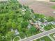 Aerial view showcasing the neighborhood with mature trees, homes, and surrounding landscape at 4526 Iowa St, Clayton, IN 46118