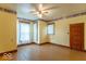 Spacious bedroom with hardwood floors, ceiling fan, and natural light from multiple windows at 4526 Iowa St, Clayton, IN 46118