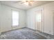 A cozy bedroom featuring neutral tones, soft carpet, and windows allowing natural light to brighten the space at 4526 Iowa St, Clayton, IN 46118