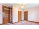 An empty bedroom featuring carpet floors, natural lighting and vintage designed doors and built in shelves at 4526 Iowa St, Clayton, IN 46118