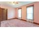 A bright bedroom featuring pink walls, wood trim and carpet flooring and lots of natural lighting at 4526 Iowa St, Clayton, IN 46118