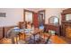 Elegant dining room with hardwood floors, vintage furniture, and ornate fireplace at 4526 Iowa St, Clayton, IN 46118