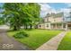 Beautiful home showcasing a lush front lawn, mature trees, a driveway, and a detached garage for added convenience at 4526 Iowa St, Clayton, IN 46118