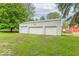 Large white three-door garage with ample space, set in a green, landscaped yard at 4526 Iowa St, Clayton, IN 46118