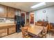 Traditional kitchen with wooden cabinetry, a black refrigerator, and dining area that highlights the home's vintage charm at 4526 Iowa St, Clayton, IN 46118