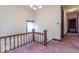 Upper landing area with hallway and pink carpet at 4526 Iowa St, Clayton, IN 46118