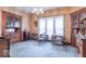 Elegant living room featuring antique furnishings, a decorative chandelier, and large windows providing ample natural light at 4526 Iowa St, Clayton, IN 46118