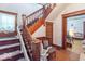 Classic staircase with wooden banister and chair lift, offering accessibility at 4526 Iowa St, Clayton, IN 46118