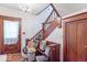 Traditional staircase with wooden railing and a chair lift for easy access at 4526 Iowa St, Clayton, IN 46118