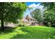 Scenic view of the home's backyard with manicured lawn and mature trees at 4623 E Windsor Ln, Columbus, IN 47201