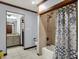 Bathroom with an enclosed shower and tub, a single sink vanity, and access to a second sink and mirror at 4623 E Windsor Ln, Columbus, IN 47201