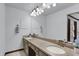 Bright bathroom with a long vanity, double sinks, granite countertop, a large mirror, and ample lighting at 4623 E Windsor Ln, Columbus, IN 47201