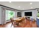 Bright dining room featuring hardwood floors, a large window, and wood dining table with chairs at 4623 E Windsor Ln, Columbus, IN 47201