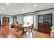 Traditional dining room with hardwood floors, a wooden table, and a glass-fronted cabinet at 4623 E Windsor Ln, Columbus, IN 47201