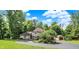 Two-story home features a circular driveway, manicured landscaping, and an American flag at 4623 E Windsor Ln, Columbus, IN 47201