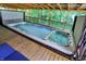 Inviting covered hot tub on a wood deck with blue lights and jets, perfect for relaxation and recreation at 4623 E Windsor Ln, Columbus, IN 47201