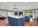 Bright open kitchen featuring kitchen islands with white countertop and blue cabinets, stainless steel appliances, and hardwood floors at 4623 E Windsor Ln, Columbus, IN 47201