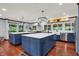Modern kitchen features blue cabinets, stainless steel appliances, and a large island at 4623 E Windsor Ln, Columbus, IN 47201
