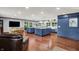 Spacious kitchen featuring two islands, a large dining table, and a sliding pantry door at 4623 E Windsor Ln, Columbus, IN 47201