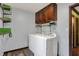 Convenient laundry room with shelving, cabinets and modern washer and dryer at 4623 E Windsor Ln, Columbus, IN 47201