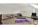 Loft area is carpeted with workout mats, a yoga ball, block, and a small TV setup at 4623 E Windsor Ln, Columbus, IN 47201