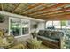 Relaxing covered patio featuring wooden deck, wicker furniture, and a view of the backyard at 4623 E Windsor Ln, Columbus, IN 47201