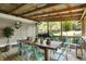 Cozy covered patio with a dining table, teal chairs, metal roof, and an open view of the backyard at 4623 E Windsor Ln, Columbus, IN 47201