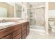 Well-lit bathroom featuring double sinks, granite countertops, and a glass-enclosed shower at 485 Thunderwood Dr, Greenfield, IN 46140