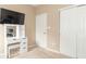 Bedroom featuring a vanity with lights, a television and a closet with double doors at 485 Thunderwood Dr, Greenfield, IN 46140
