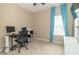 This carpeted bedroom includes a computer desk and shelving, an office chair, and a window with blue curtains at 485 Thunderwood Dr, Greenfield, IN 46140