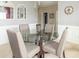 Chic dining room with glass table, four upholstered chairs, and decorative wall art at 485 Thunderwood Dr, Greenfield, IN 46140