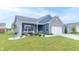 View of the blue, one-story home featuring a welcoming front porch, well-maintained lawn, and tidy landscaping at 485 Thunderwood Dr, Greenfield, IN 46140