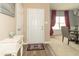Inviting foyer with neutral decor, white accents, and view into the dining area with elegant curtains at 485 Thunderwood Dr, Greenfield, IN 46140