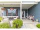 Inviting front porch with comfortable seating, hanging floral baskets, and charming welcome decor at 485 Thunderwood Dr, Greenfield, IN 46140
