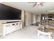 Spacious living room view featuring a large television and ample seating adjacent to the modern kitchen at 485 Thunderwood Dr, Greenfield, IN 46140
