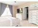 Calming bedroom with a neutral color scheme, large window, and TV console at 485 Thunderwood Dr, Greenfield, IN 46140