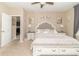 Bright main bedroom with a tufted headboard, side tables, and neutral decor at 485 Thunderwood Dr, Greenfield, IN 46140