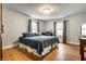 Bedroom with hardwood floors, two windows, and a blue comforter at 4912 Central Ave, Indianapolis, IN 46205