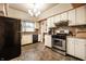 Charming kitchen features a gas range, stainless steel appliances and exposed brick accent wall at 4912 Central Ave, Indianapolis, IN 46205