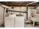 Basement laundry room featuring a washer, dryer, and utility sink at 4912 Central Ave, Indianapolis, IN 46205