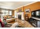Comfortable living room features a fireplace, hardwood floors, and large picture window at 4912 Central Ave, Indianapolis, IN 46205