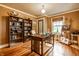 Home office with wooden bookshelves, desk, and an easel at 4912 Central Ave, Indianapolis, IN 46205