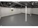 Unfinished basement featuring a gray painted floor, white walls, and visible ceiling infrastructure at 4933 W 13Th W St, Speedway, IN 46224