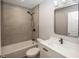 Newly renovated bathroom showcasing modern fixtures, tiled shower, and a sleek vanity with sink at 4933 W 13Th W St, Speedway, IN 46224